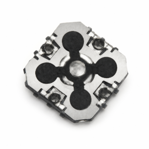 Close-up of a metallic mechanical part: a square silver plate with three black circular pads arranged around a central hub.