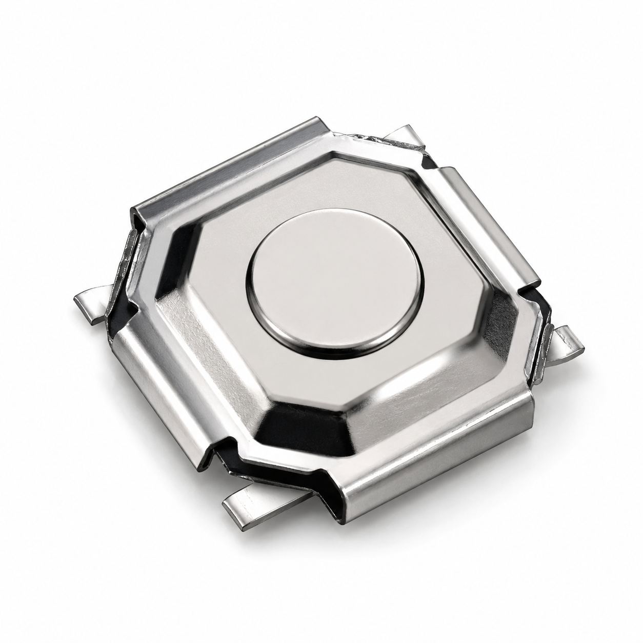 Close-up of a reflective octagonal metal housing with a central circular button and metal clips at the edges.